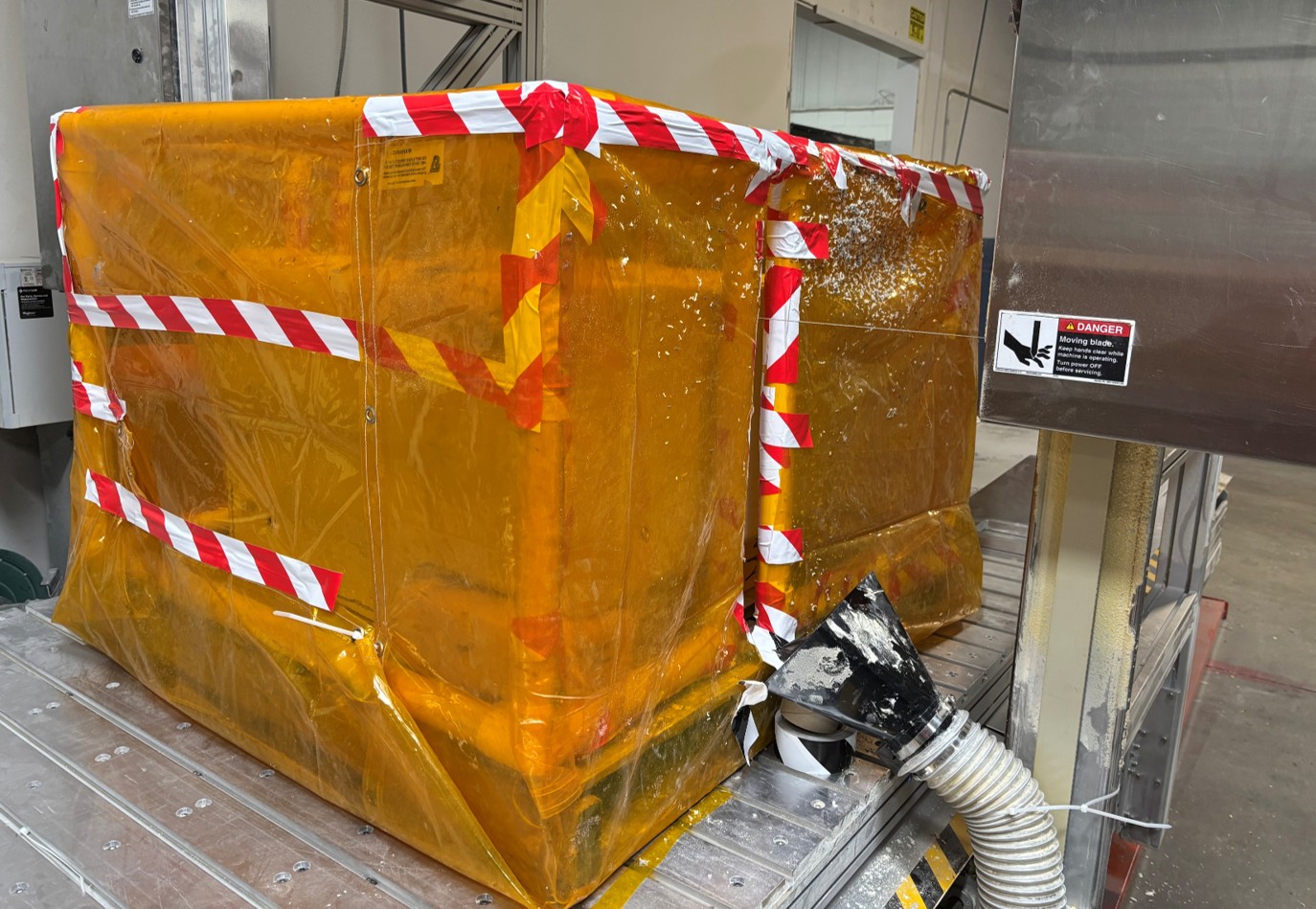 Temporary wire saw containment enclosure installed on the machine